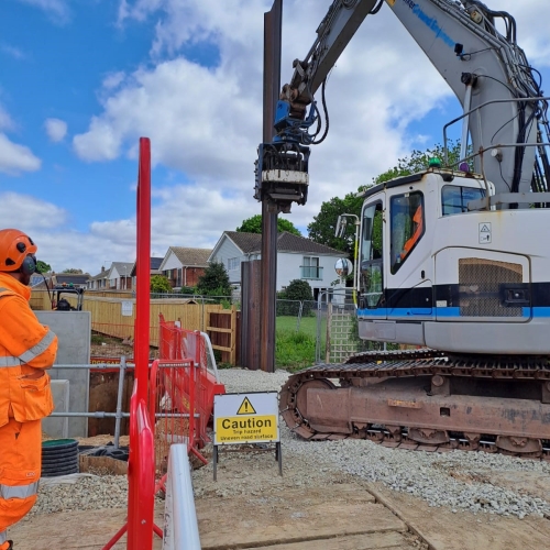 Piling machine inserting a pile into the ground at a construction site