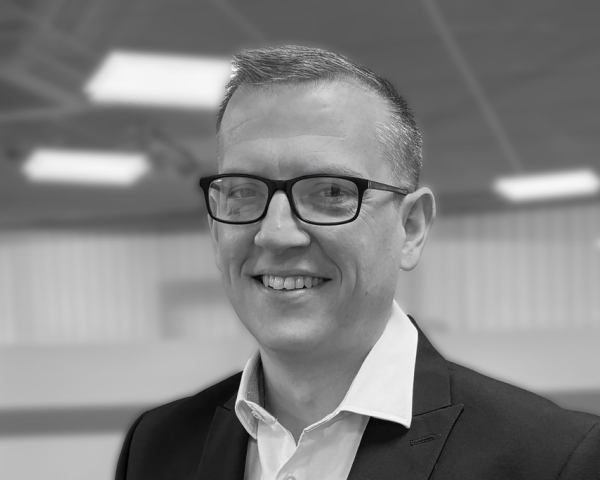 Headshot of David Coyle in black and white